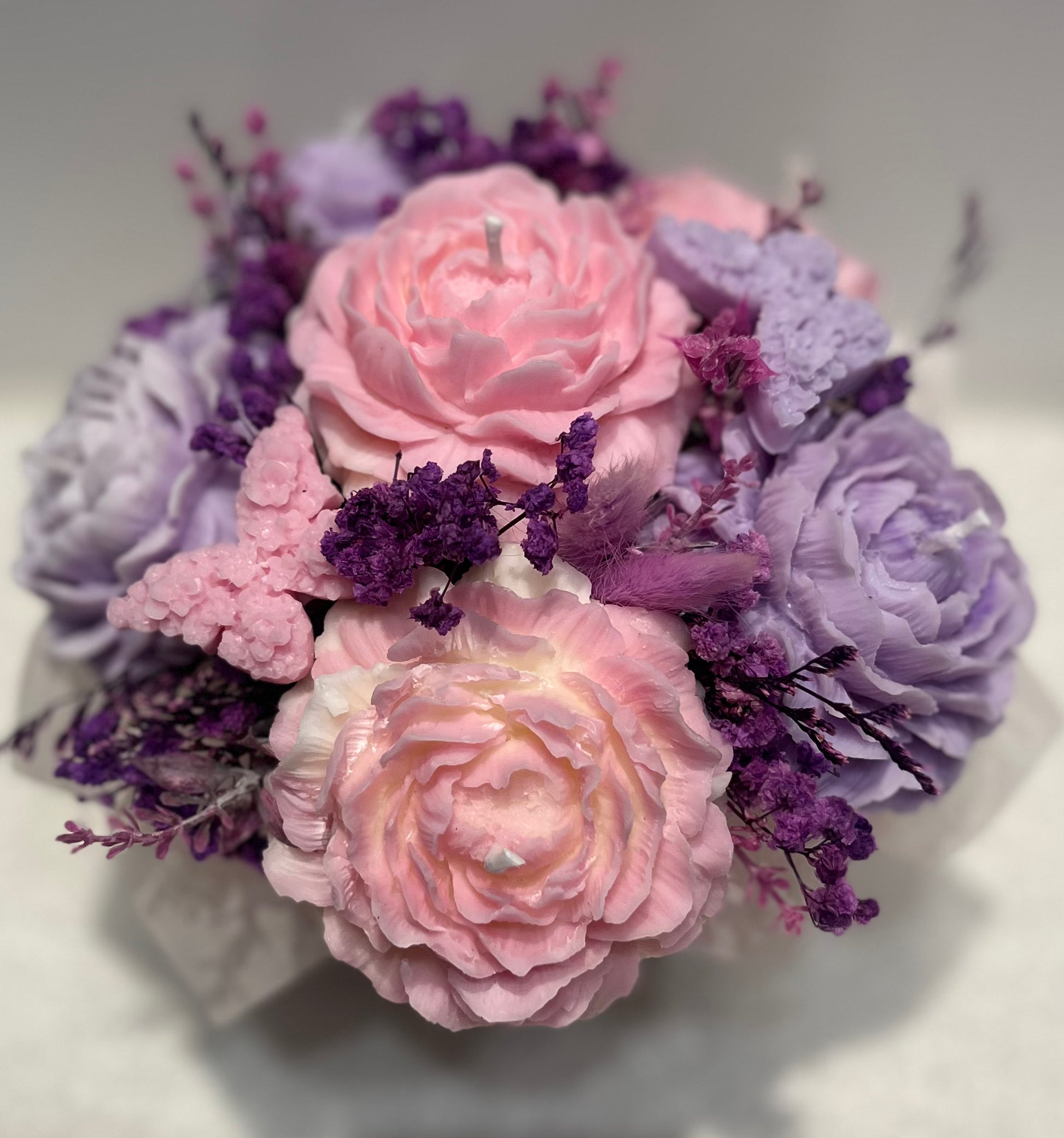 Bouquet of pink and purple flowers on a light gray background