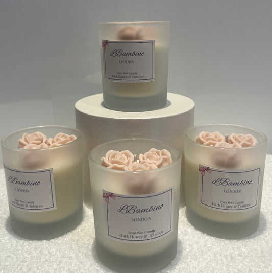Set of candles with floral designs and 'Lé Bambino London' labels on a white background